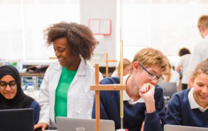 Researchers discussing with students in a classroom setting