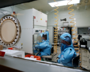 Two research workers in protective gear in NIAID lab