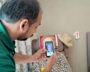 Care giver using phone app to monitor patient's pain levels