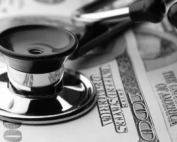 Stethoscope resting on top of American dollar bills