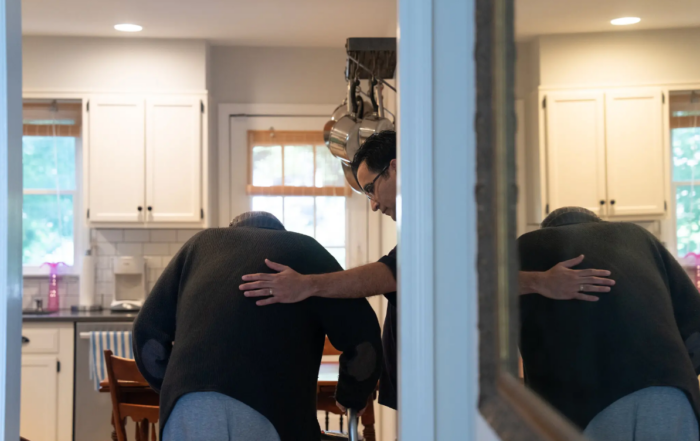 Caregiver offers support to elderly man