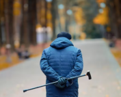 Man walking with cane in hand