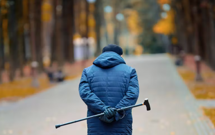 Man walking with cane in hand