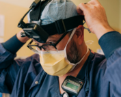 Medical professional in scrubs putting on head gear