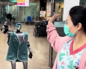 Hospital worker waving at robot